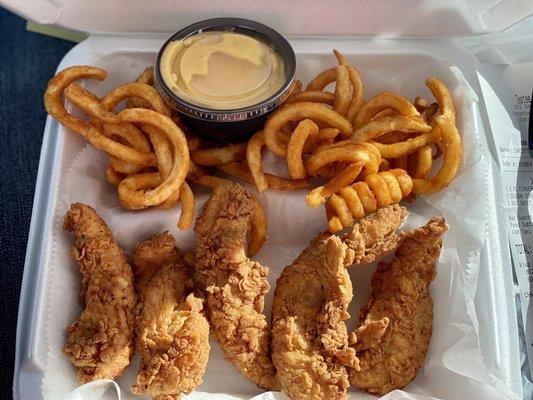 Chicken fingers with curly fries and honey mustard sauce