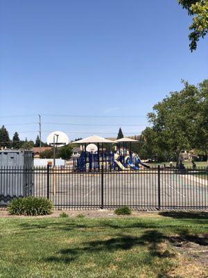 Hoops in front, playgrounds in back.