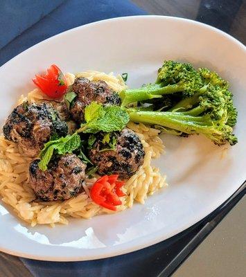 Meatballs, caramelized broccoli, and orzo.