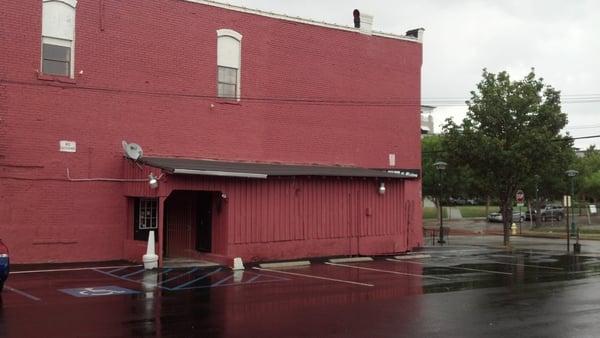 The front door is there inside the sheltered area.