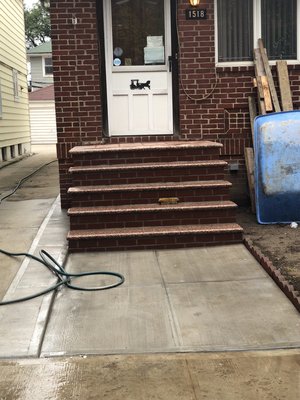 New steps and concrete in the walkway of the house.