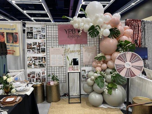 Seattle Wedding show 2023. Your Perfect Bridesmaid booth. Organic balloon garland with live orchids and foliage. Perfect for weddings!