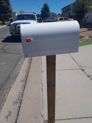 They put a new mailbox post up and put the same broken mailbox with no flag on it