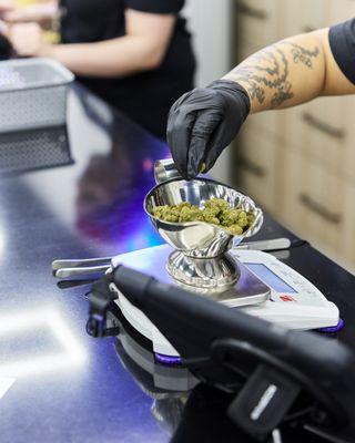 JARS Mile High - budtender measuring out deli flower