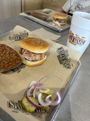 Pulled pork sandwich with baked beans.