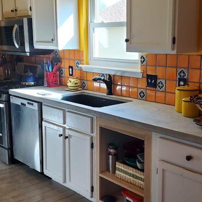 Concrete countertop and clay tile backsplash