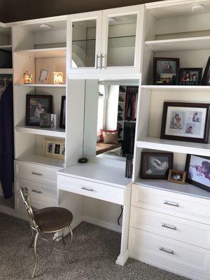 Walk-in closet with vanity.