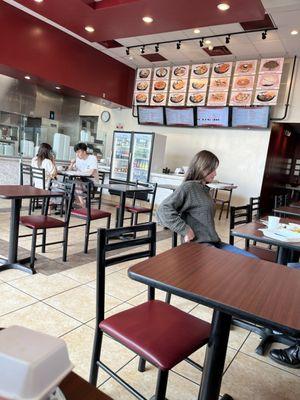 Restaurant space, there are two outdoor tables with two chairs each.