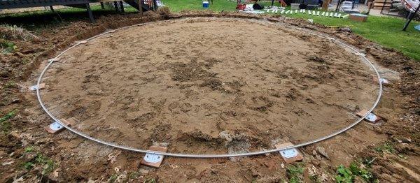 Laying and leveling block and bottom rail for new pool