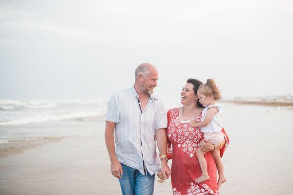 Beautiful family walking the Port Aransas beach on a misty, windy evening. Port Aransas Photography Megan Biggs Photography