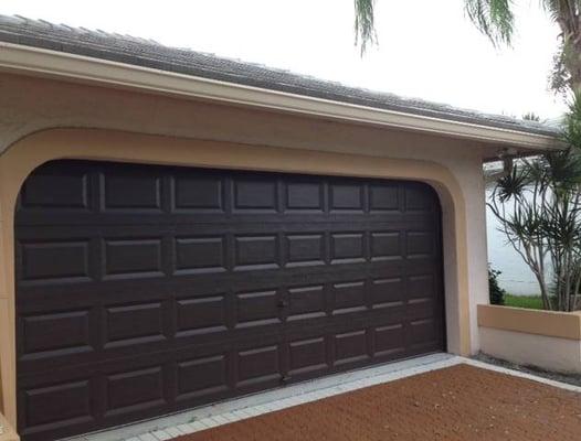 South FL Gutters Depot seamless gutter across garage and down to the ground.