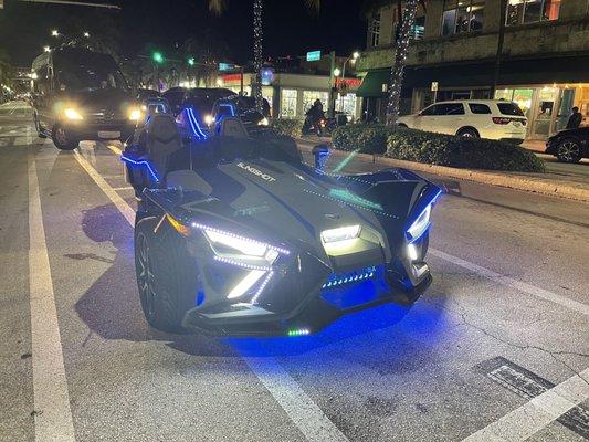 Slingshot at night on Washington Ave in Miami Beach. LEDs fully illuminated.