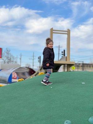 The middle of the park climbing mound with a slide