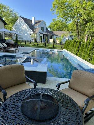 Water feature wall with sheet falls on this custom gunite pool and spa combo.