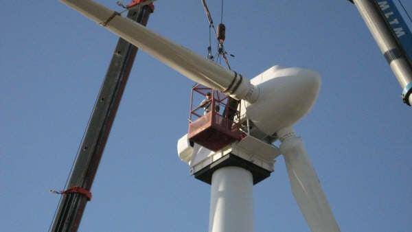 OGW Energy Resources&#39; President, Ray Davis stabbing turbine blades in Kansas.