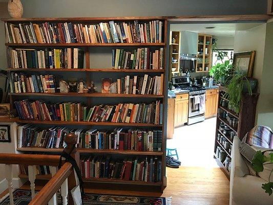 Black acacia built-in sliding dovetail bookcase.