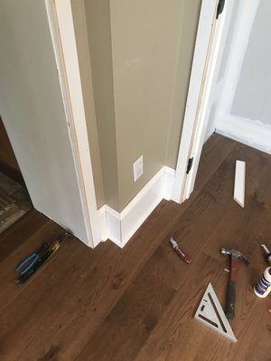 Laminate flooring & baseboard/door trim being installed