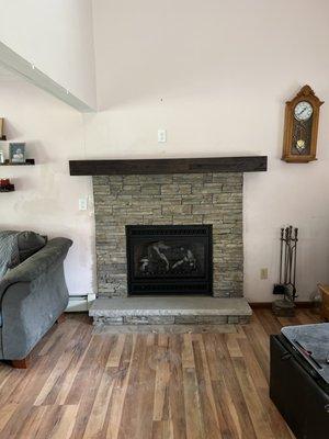 Installed stone, mantel, and hearth.