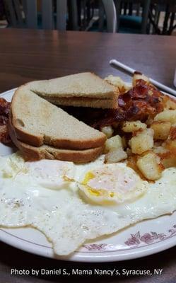 2 eggs, choice of meat, home fries & toast is $6.25 at time of writing for Mama Nancy's