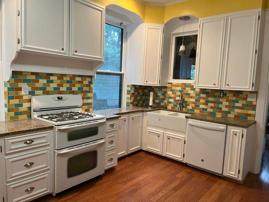 Granite countertop and new ceramic tile backsplash.