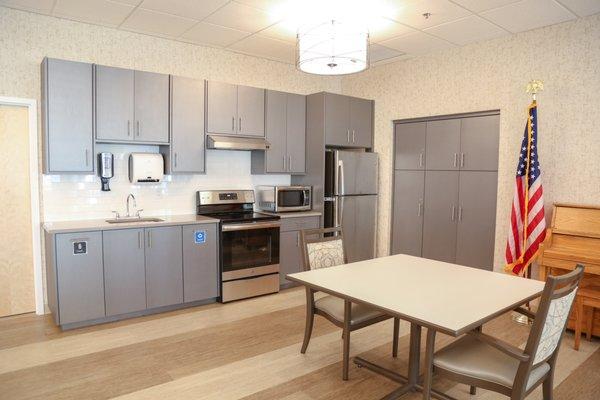 The dining room with a view of the side, outward facing kitchen.