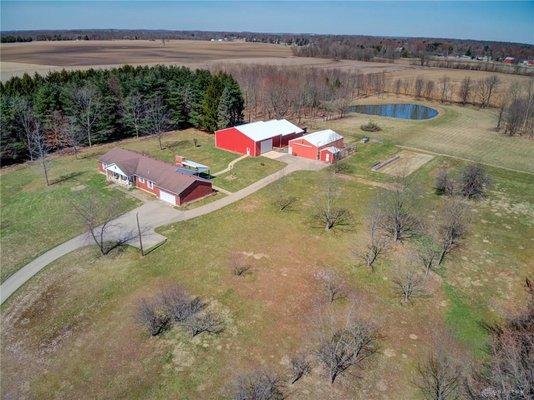 Now this is the dream! This mini farm w/ a machine shop & barns sold quick. By using professional drone shots, it got a lot of attention.