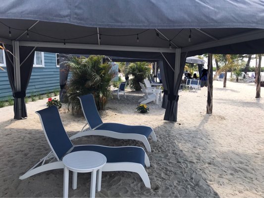 Lounge chairs. Larger table in very background of photo.