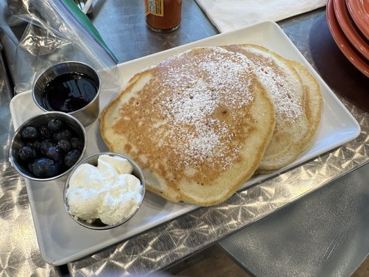 Short stack with a side of seasonal fruit. Choices are (usually) strawberry and blueberry, or a mix.