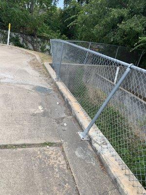 Fencing so broken it's not even attached to the concrete.