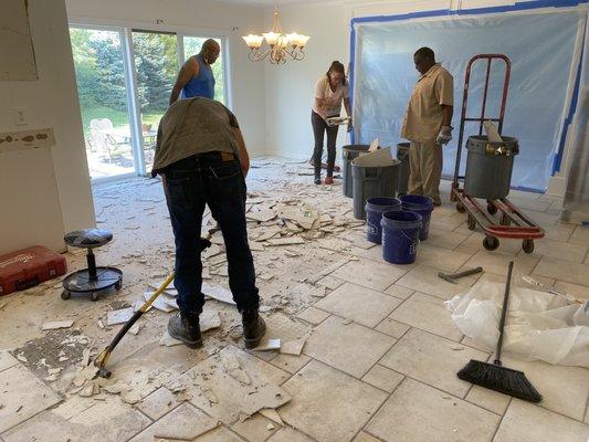 Demo team ripping out old tile