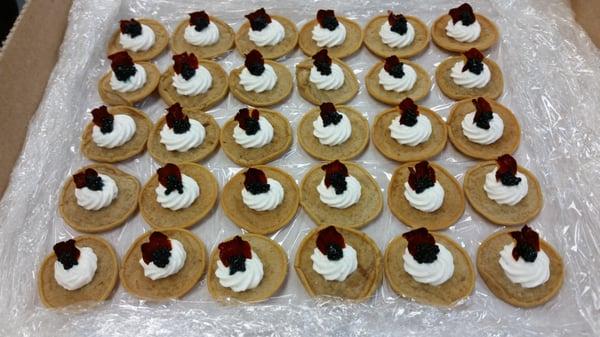 Cinnamon Nutmeg Creme Fresh on Pumpkin Blini Garnished with Caviar and Flowers