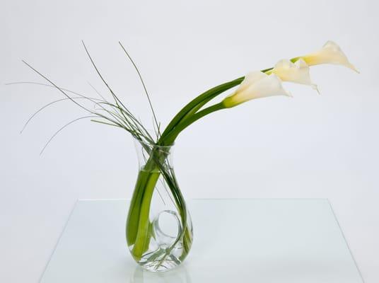 Gorgeous calla lillies in a reusable   wine caraffe. ~ One of our keepsake designs.