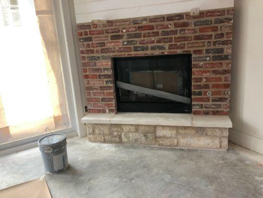 Rock to brick transition fireplace