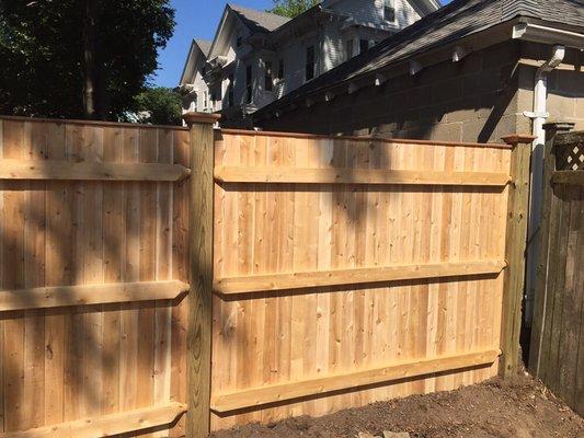 6 foot high board fence with 2 x 4 backing Rails