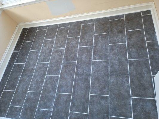 Damaged floor tiled and grouted.