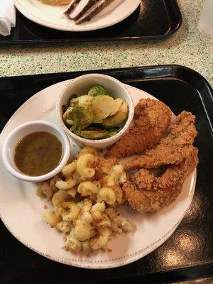 Chicken strip plate with honey mustard, Brussels sprouts and mac n cheese.