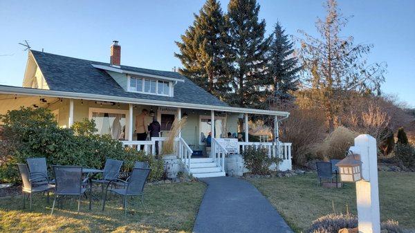 Building for wine tasting with wrap around porch with ceiling header