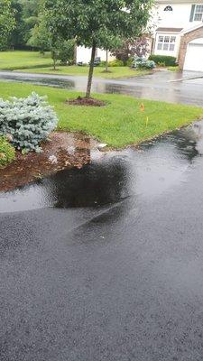 Water puddled up in new driveway by Dow Asphalt and Pavers