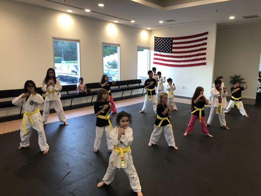 Our yellow belts show here warming up in the beginning of their class.