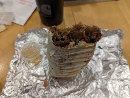 Shanghai Steak Burrito balanced with a couple of bites missing. Wanted to make sure it was tasty