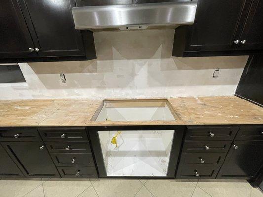 Oven and counter after demo and plywood