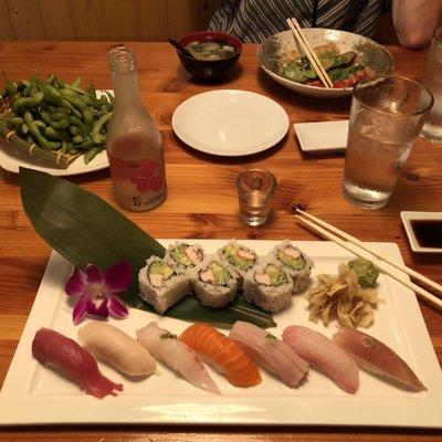 Sushi regular, edamame, sake, and a house salad.