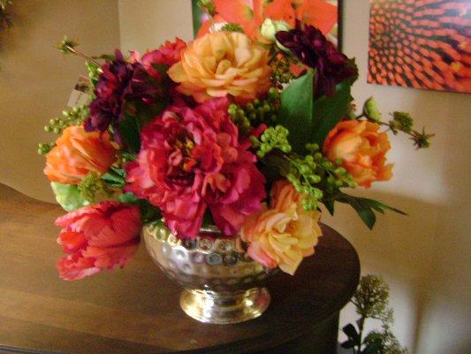 Mix of colorful flowers in an antique silver bowl.