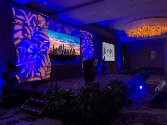 Custom made LED wall in the center. Two projection screens on the side. Lighting, movie lights and patterns. Sound system and lighting.