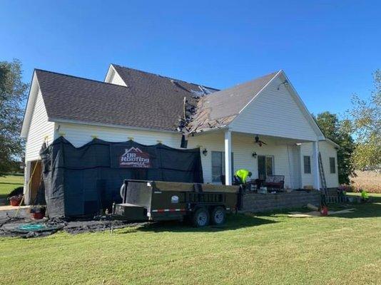 Working hard on replacing a Old storm damage roof for a family in Martin Tennessee