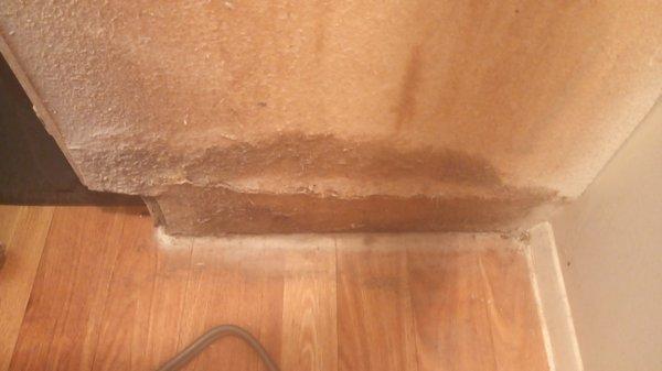 Water damage between kitchen cabinets and the stove.