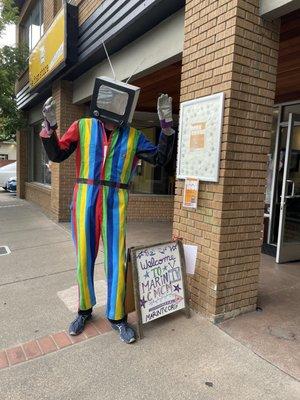 Media Man greets passers by with his TV head.