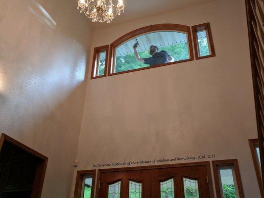 Window washing at a home with beautiful themed scripture through the house.