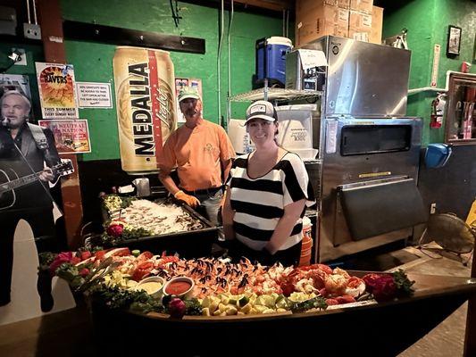 Oyster and clam raw bar in the back and a crab claw and lobster tail buffet in front.