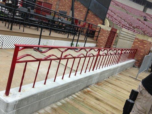 The red rail is a custom "wave" rail. The black in the background is standard steel pipe rail.